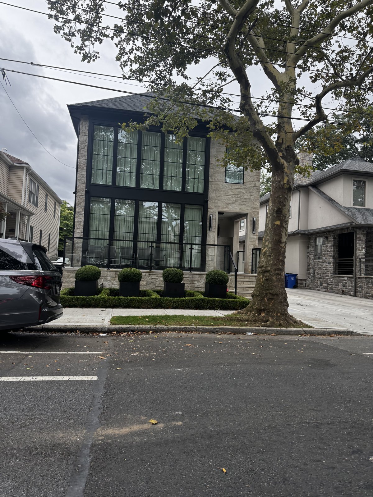 Modern stone facade home with floor-to-ceiling black-framed windows