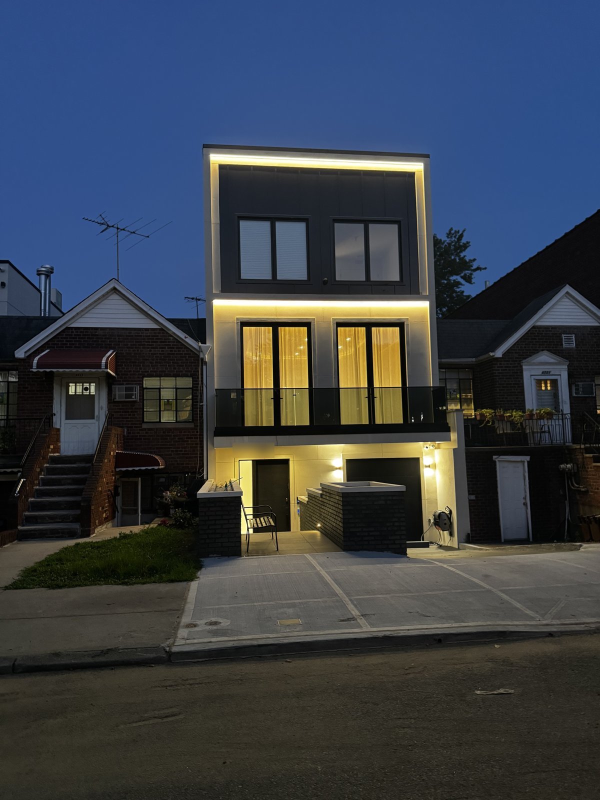 Contemporary home exterior at dusk with warm architectural lighting
