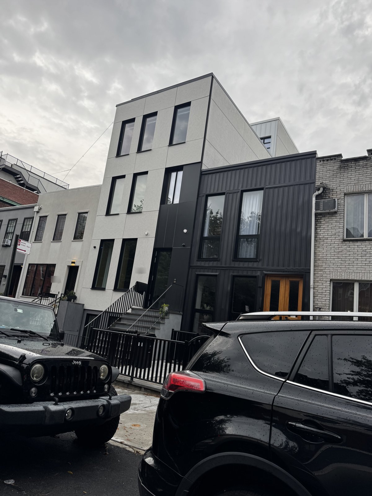 Modern two-tone black and stone townhouse exterior